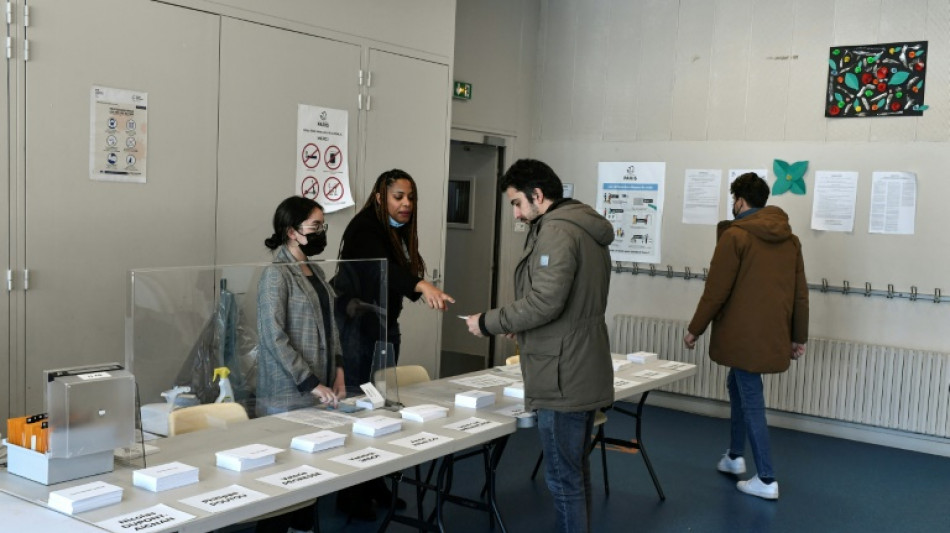 France votes with Macron seeking new term in tight election