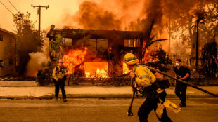 Shocked LA residents survey fire damage, brace for more